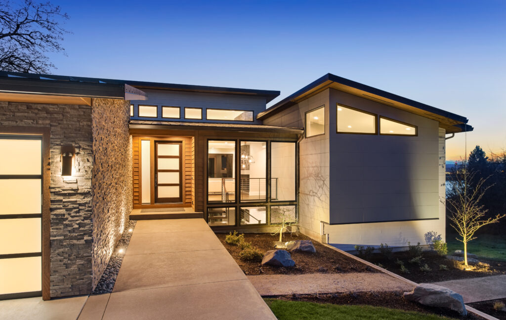 Modern single-storey home exterior at dusk — the scale of project a home addition typically produces